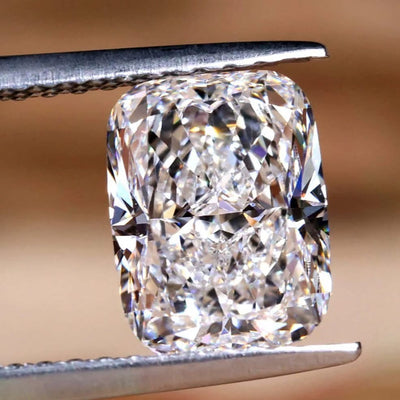 Diamond held by tweezers against a neutral background